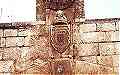 Particolare dell'ingresso lato est: il presunto stemma sabaudo, sormontato da un busto di san Nicola